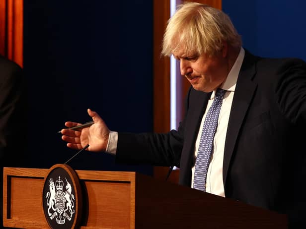 Prime Minister Boris Johnson gestures whilst speaking at a press conference in London's Downing Street after ministers met to consider imposing new restrictions in response to rising cases and the spread of the Omicron variant. Picture date: Wednesday December 8, 2021.