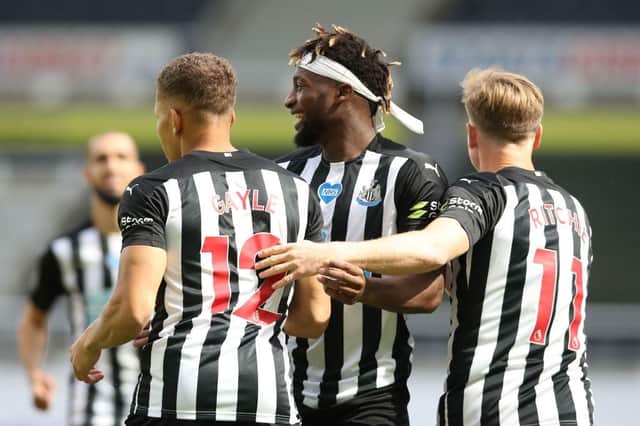 Dwight Gayle, left, is congratulated by Allan Saint-Maximin, centre, and Matt Ritchie.