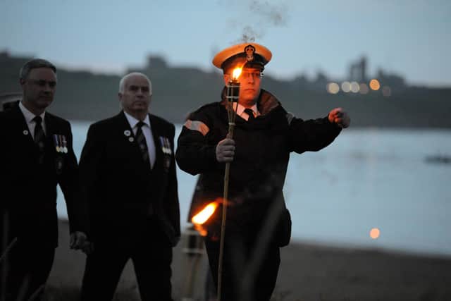 TS Collingtwood Sea Cadets carry the flame to be handed to veteran Joe Smith-Bailes to light the first of two beacons in South Shields to mark the Queen's Platinum Jubilee.