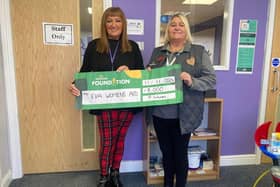 Richinda Taylor, EVA Women’s Aid CEO proudly being presented with a donation of £8,000 from Pam Wilkes, Morrisons Community Champion