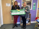 Richinda Taylor, EVA Women’s Aid CEO proudly being presented with a donation of £8,000 from Pam Wilkes, Morrisons Community Champion