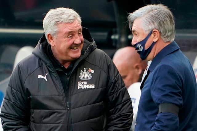 Newcastle United's English head coach Steve Bruce (L) talks with Everton's Italian head coach Carlo Ancelotti (R) on the touchline before kick off of the English Premier League football match between Newcastle United and Everton at St James' Park in Newcastle-upon-Tyne, north east England on November 1, 2020.