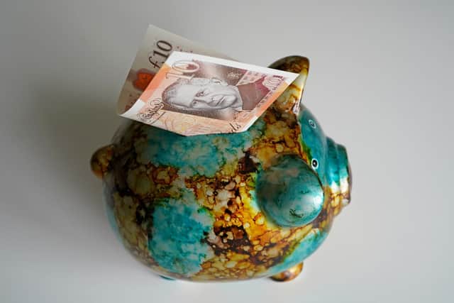 A £10 note in a piggy bank. PIC: Gareth Fuller/PA Wire