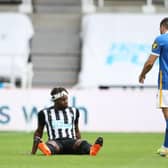 Newcastle United's French midfielder Allan Saint-Maximin sits on the pitch after being injured during the English Premier League football match between Newcastle United and Brighton and Hove Albion at St James' Park in Newcastle upon Tyne, north-east England on September 20, 2020.