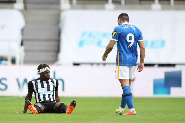 Newcastle United's French midfielder Allan Saint-Maximin sits on the pitch after being injured during the English Premier League football match between Newcastle United and Brighton and Hove Albion at St James' Park in Newcastle upon Tyne, north-east England on September 20, 2020.