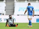 Newcastle United's French midfielder Allan Saint-Maximin sits on the pitch after being injured during the English Premier League football match between Newcastle United and Brighton and Hove Albion at St James' Park in Newcastle upon Tyne, north-east England on September 20, 2020.