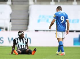 Newcastle United's French midfielder Allan Saint-Maximin sits on the pitch after being injured during the English Premier League football match between Newcastle United and Brighton and Hove Albion at St James' Park in Newcastle upon Tyne, north-east England on September 20, 2020.