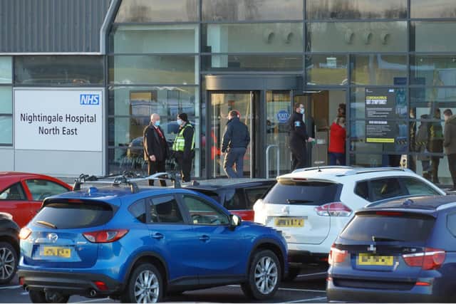 The hospital car park was busy as a line of people waited to enter the facility at the instruction of security staff on the door.