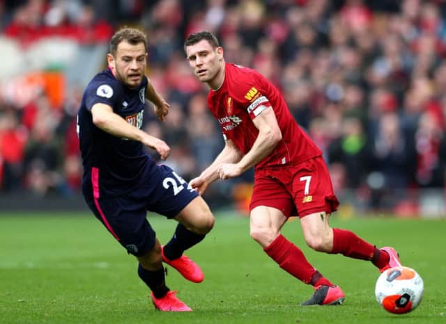 LIVERPOOL, ENGLAND - MARCH 07: Ryan Fraser of AFC Bournemouth battles for possession with James Milner of Liverpool during the Premier League match between Liverpool FC and AFC Bournemouth  at Anfield on March 07, 2020 in Liverpool, United Kingdom. (Photo by Jan Kruger/Getty Images)