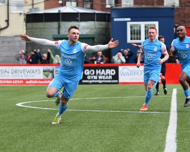 Mackenzie Heaney celebrates after opening the scoring against Hyde United