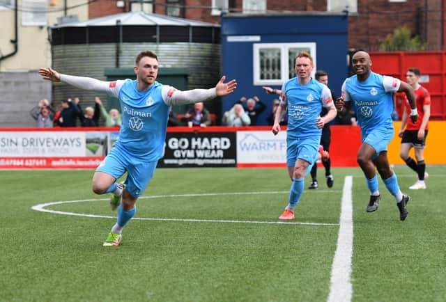 Mackenzie Heaney celebrates after opening the scoring against Hyde United