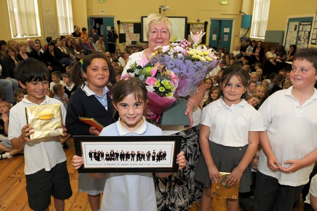 Retiring teacher Helen Smyth receives flowers and gifts from pupils at St Gregory's RC Primary School in 2010.