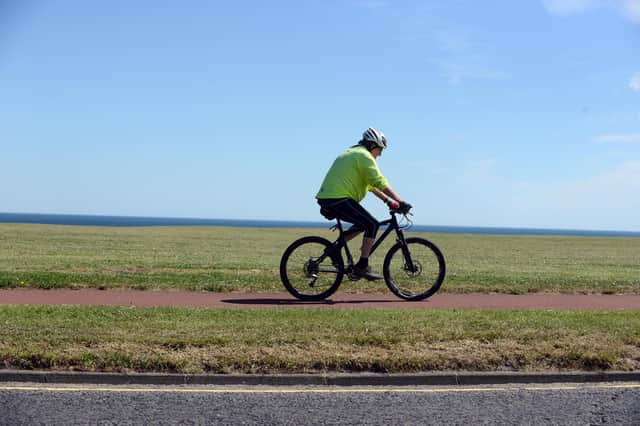 A cyclist enjoys sunny weather along the Coast Road in South Shields