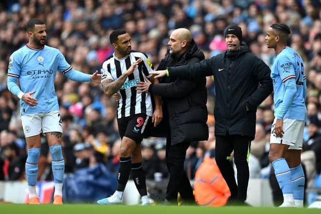 Pep Guardiola, Manager of Manchester City, attempts to break up a clash between Callum Wilson of Newcastle United and Manuel Akanji of Manchester City during the Premier League match between Manchester City and Newcastle United at Etihad Stadium on March 04, 2023 in Manchester, England. (Photo by Michael Regan/Getty Images)