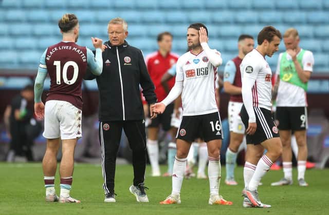 BIRMINGHAM, ENGLAND - JUNE 17: Chris Wilder, Manager of Sheffield United interacts with Jack Grealish of Aston Villa after the the Premier League match between Aston Villa and Sheffield United at Villa Park on June 17, 2020 in Birmingham, England. (Photo by Carl Recine/Pool via Getty Images)