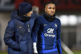 France's national football team forward Christopher Nkunku (R) reacts after injured during a training session at the team's training camp in Clairefontaine-en-Yvelines, south of Paris, on November 15, 2022, five days ahead of the Qatar 2022 FIFA World Cup football tournament. (Photo by Bertrand GUAY / AFP) (Photo by BERTRAND GUAY/AFP via Getty Images)