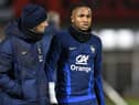 France's national football team forward Christopher Nkunku (R) reacts after injured during a training session at the team's training camp in Clairefontaine-en-Yvelines, south of Paris, on November 15, 2022, five days ahead of the Qatar 2022 FIFA World Cup football tournament. (Photo by Bertrand GUAY / AFP) (Photo by BERTRAND GUAY/AFP via Getty Images)