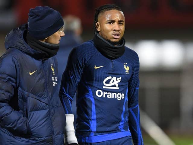 France's national football team forward Christopher Nkunku (R) reacts after injured during a training session at the team's training camp in Clairefontaine-en-Yvelines, south of Paris, on November 15, 2022, five days ahead of the Qatar 2022 FIFA World Cup football tournament. (Photo by Bertrand GUAY / AFP) (Photo by BERTRAND GUAY/AFP via Getty Images)