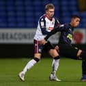 Rodrigo Vilca of Newcastle United U21's on the ball with Jak Hickman of Bolton Wanderers during the EFL Trophy match between Bolton Wanderers and Newcastle United U21 at University of Bolton Stadium on November 17, 2020 in Bolton, England. Sporting stadiums around the UK remain under strict restrictions due to the Coronavirus Pandemic as Government social distancing laws prohibit fans inside venues resulting in games being played behind closed doors. (Photo by Charlotte Tattersall/Getty Images)