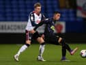 Rodrigo Vilca of Newcastle United U21's on the ball with Jak Hickman of Bolton Wanderers during the EFL Trophy match between Bolton Wanderers and Newcastle United U21 at University of Bolton Stadium on November 17, 2020 in Bolton, England. Sporting stadiums around the UK remain under strict restrictions due to the Coronavirus Pandemic as Government social distancing laws prohibit fans inside venues resulting in games being played behind closed doors. (Photo by Charlotte Tattersall/Getty Images)