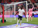 England's defender Bukayo Saka celebrates scoring the opening goal during the international friendly football match between England and Austria at the Riverside Stadium.