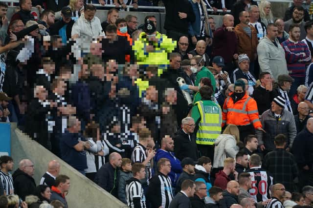 Medical personal are called to assist a fan in the stands during the Premier League match at St. James' Park, Newcastle. Picture PA.