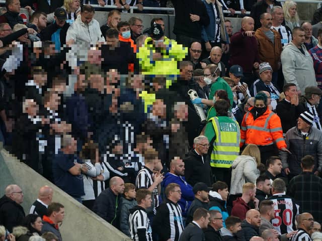 Medical personal are called to assist a fan in the stands during the Premier League match at St. James' Park, Newcastle. Picture PA.