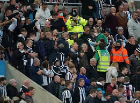 Medical personal are called to assist a fan in the stands during the Premier League match at St. James' Park, Newcastle. Picture PA.