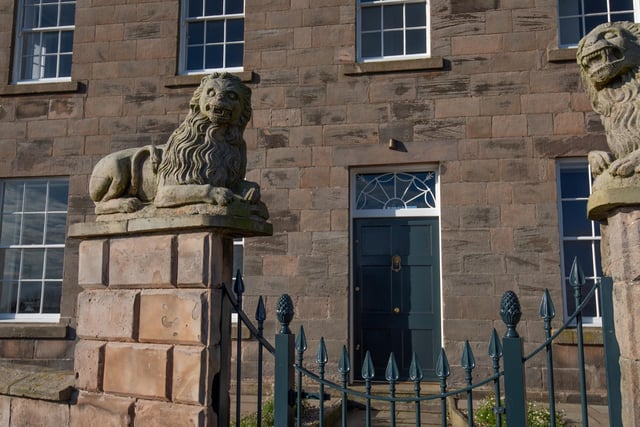 Stone carved lions guard the entrance.