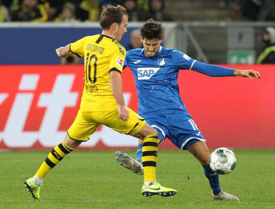 Dortmund's German midfielder Mario Goetze (L) and Hoffenheim's Austrian midfielder Florian Grillitsch vie for the ball during the German First division Bundesliga football match TSG 1899 Hoffenheim v BVB Borussia Dortmund in Sinsheim, southern Germany, on December 20, 2019. (Photo by Daniel ROLAND / AFP) / DFL REGULATIONS PROHIBIT ANY USE OF PHOTOGRAPHS AS IMAGE SEQUENCES AND/OR QUASI-VIDEO (Photo by DANIEL ROLAND/AFP via Getty Images)