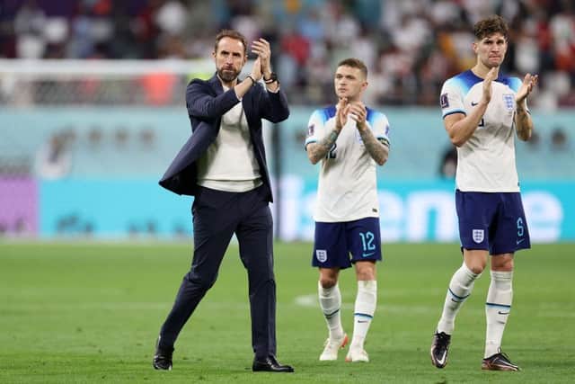 Gareth Southgate, Head Coach of England, applauds fans with Kieran Trippier and John Stones after the 6-2 win during the FIFA World Cup Qatar 2022 Group B match between England and IR Iran at Khalifa International Stadium on November 21, 2022 in Doha, Qatar. (Photo by Richard Heathcote/Getty Images)