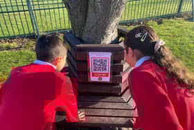 Children from St Joseph's Catholic Primary School with one of the QR codes.