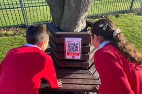 Children from St Joseph's Catholic Primary School with one of the QR codes.