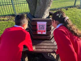 Children from St Joseph's Catholic Primary School with one of the QR codes.