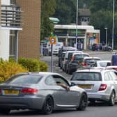 Cars queue for fuel at a BP petrol station in Bracknell, Berkshire, on Sunday, September 26.