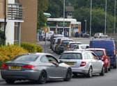 Cars queue for fuel at a BP petrol station in Bracknell, Berkshire, on Sunday, September 26.