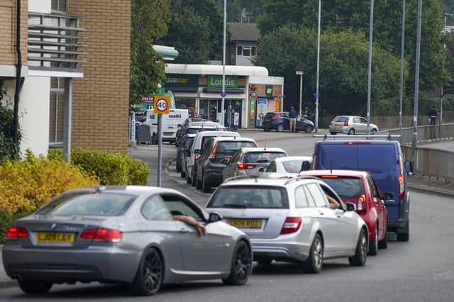 Cars queue for fuel at a BP petrol station in Bracknell, Berkshire, on Sunday, September 26.