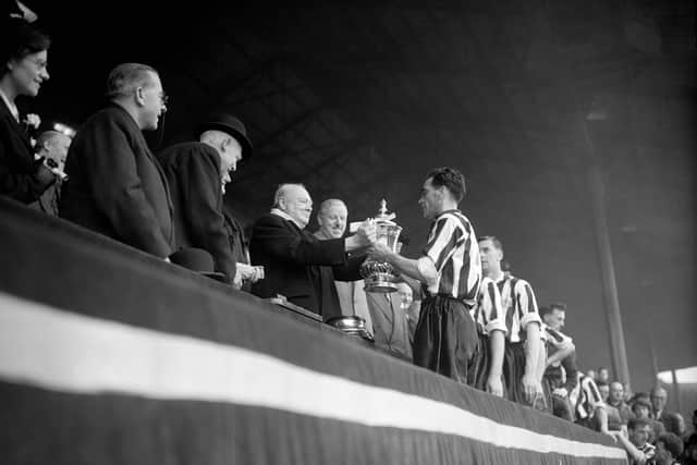 Prime Minister Winston Churchill presents the FA Cup to the winning captain, Newcastle United's Joe Harvey. PA Photo.