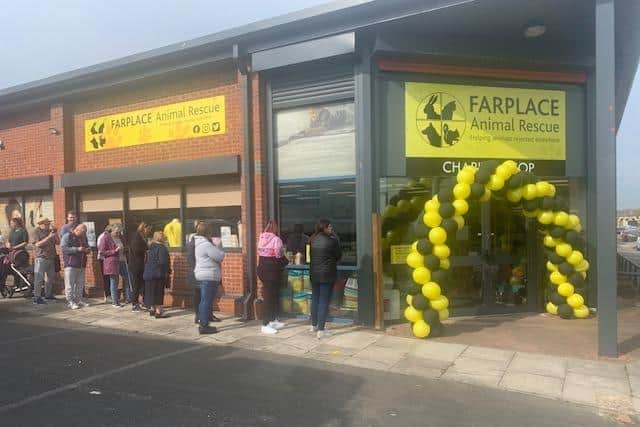 A queue outside the shop as it prepares to open.