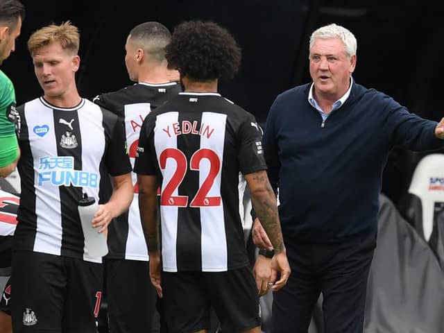 Newcastle United's English head coach Steve Bruce (R) speaks with his players during a drinks break in the English Premier League football match between Newcastle United and Tottenham Hotspur at St James' Park in Newcastle-upon-Tyne, north-east England on July 15, 2020.