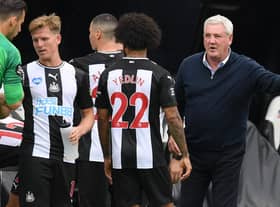 Newcastle United's English head coach Steve Bruce (R) speaks with his players during a drinks break in the English Premier League football match between Newcastle United and Tottenham Hotspur at St James' Park in Newcastle-upon-Tyne, north-east England on July 15, 2020.