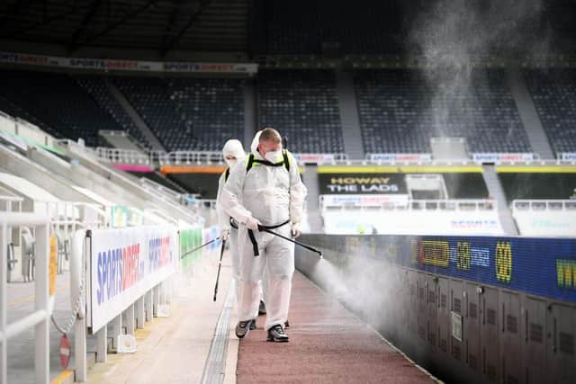 Workers spray disinfectant at St James's Park in June 2020.