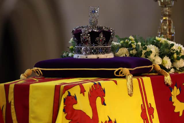 The coffin of Queen Elizabeth II, draped in the Royal Standard with the Imperial State Crown placed on top, lays on the catafalque in Westminster Hall, London, where it will lie in state ahead of her funeral on Monday. Picture date: Wednesday September 14, 2022.