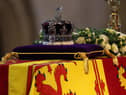 The coffin of Queen Elizabeth II, draped in the Royal Standard with the Imperial State Crown placed on top, lays on the catafalque in Westminster Hall, London, where it will lie in state ahead of her funeral on Monday. Picture date: Wednesday September 14, 2022.