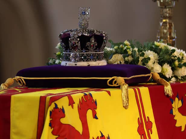 The coffin of Queen Elizabeth II, draped in the Royal Standard with the Imperial State Crown placed on top, lays on the catafalque in Westminster Hall, London, where it will lie in state ahead of her funeral on Monday. Picture date: Wednesday September 14, 2022.