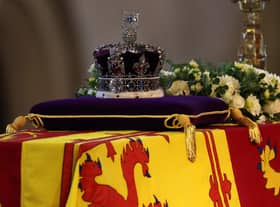 The coffin of Queen Elizabeth II, draped in the Royal Standard with the Imperial State Crown placed on top, lays on the catafalque in Westminster Hall, London, where it will lie in state ahead of her funeral on Monday. Picture date: Wednesday September 14, 2022.