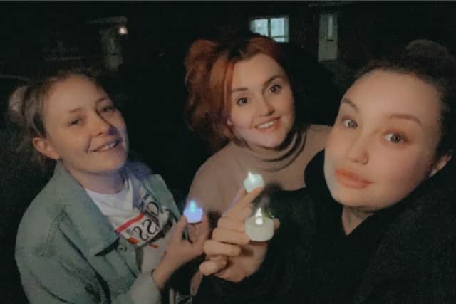 Organiser Rebekah O'Connor (middle) with her neighbours Sophie Taylor (left) and Emily Percival (right) during the  minute of silence for Sarah Everard.