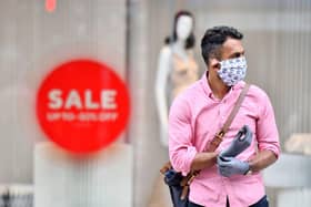 A man wearing a face covering and gloves as precautions against the transmission of the novel coronavirus. Face masks will be compulsory in shops and supermarkets in England from Friday, July 24 the government said. (Photo by JUSTIN TALLIS/AFP via Getty Images)