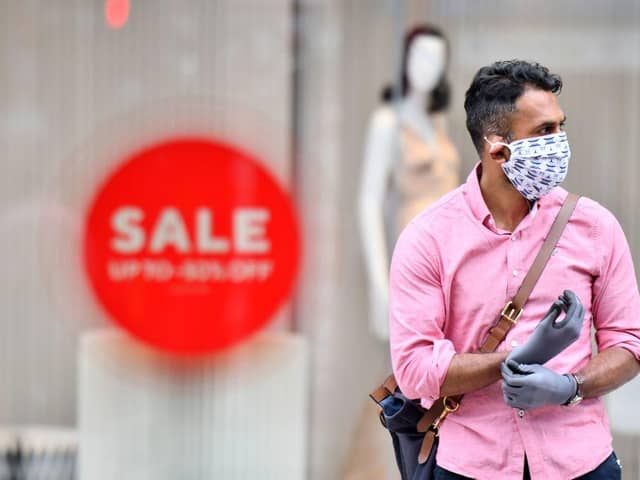 A man wearing a face covering and gloves as precautions against the transmission of the novel coronavirus. Face masks will be compulsory in shops and supermarkets in England from Friday, July 24 the government said. (Photo by JUSTIN TALLIS/AFP via Getty Images)
