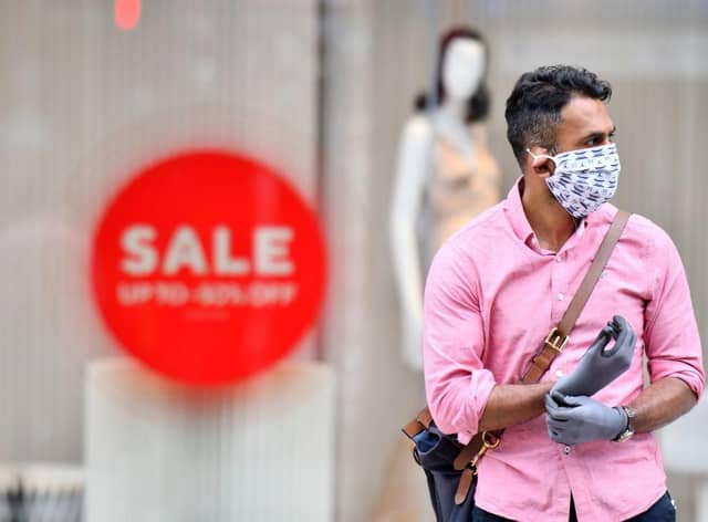 A man wearing a face covering and gloves as precautions against the transmission of the novel coronavirus. Face masks will be compulsory in shops and supermarkets in England from Friday, July 24 the government said. (Photo by JUSTIN TALLIS/AFP via Getty Images)